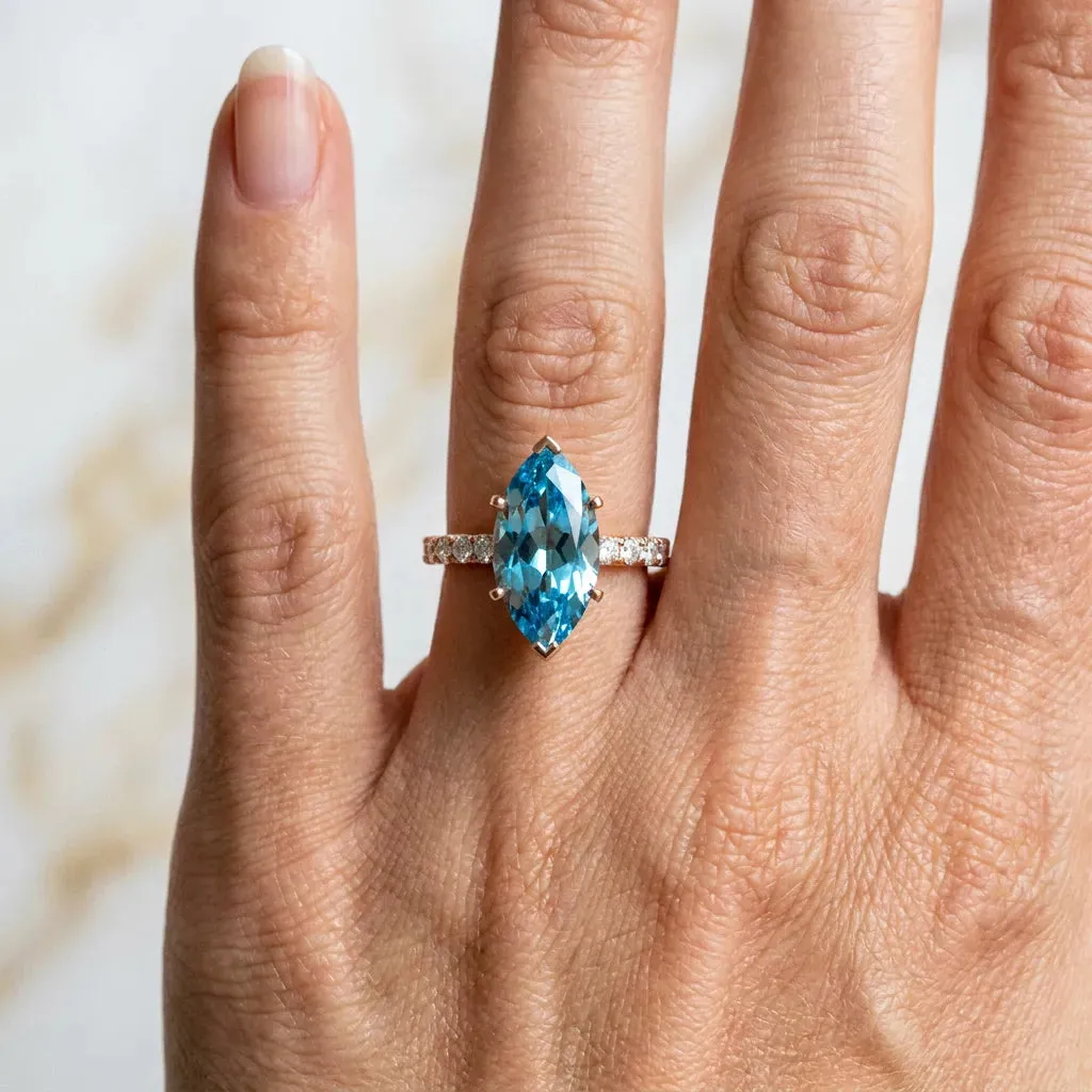 Marquise Cut Blue Topaz Solitaire Ring with Round Pavé Band and Four-Prong Setting Rose gold