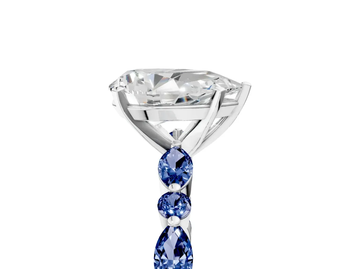 Pear Cut Diamond Ring with Marquise and Round Blue Sapphire Side Stones and Four-Prong Setting Platinum