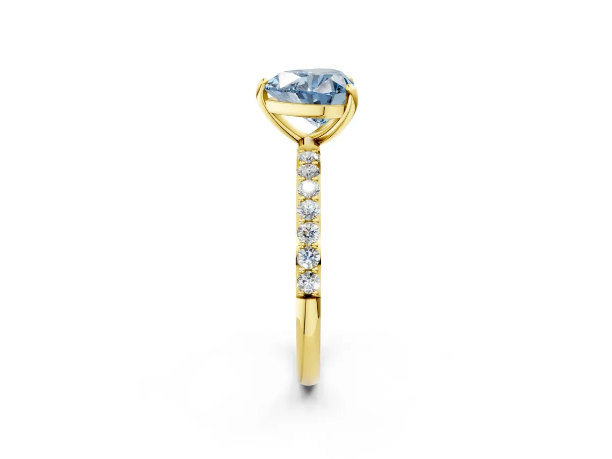Fancy Blue Heart Cut Diamond Solitaire Ring with Round Pavé Band and Prong Setting Yellow gold
