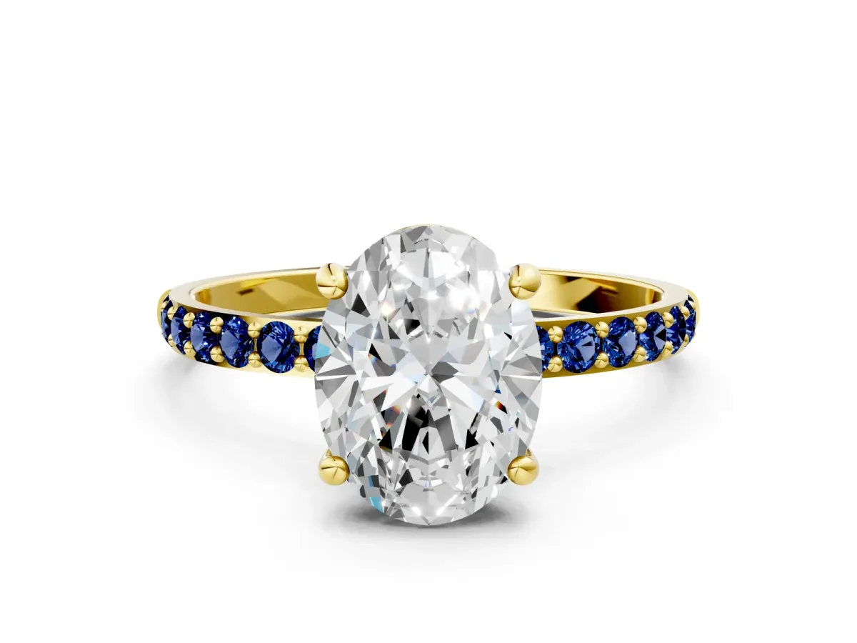 Oval Cut Diamond Solitaire Ring with Round Blue Sapphire Pavé Band and Prong Setting Yellow gold