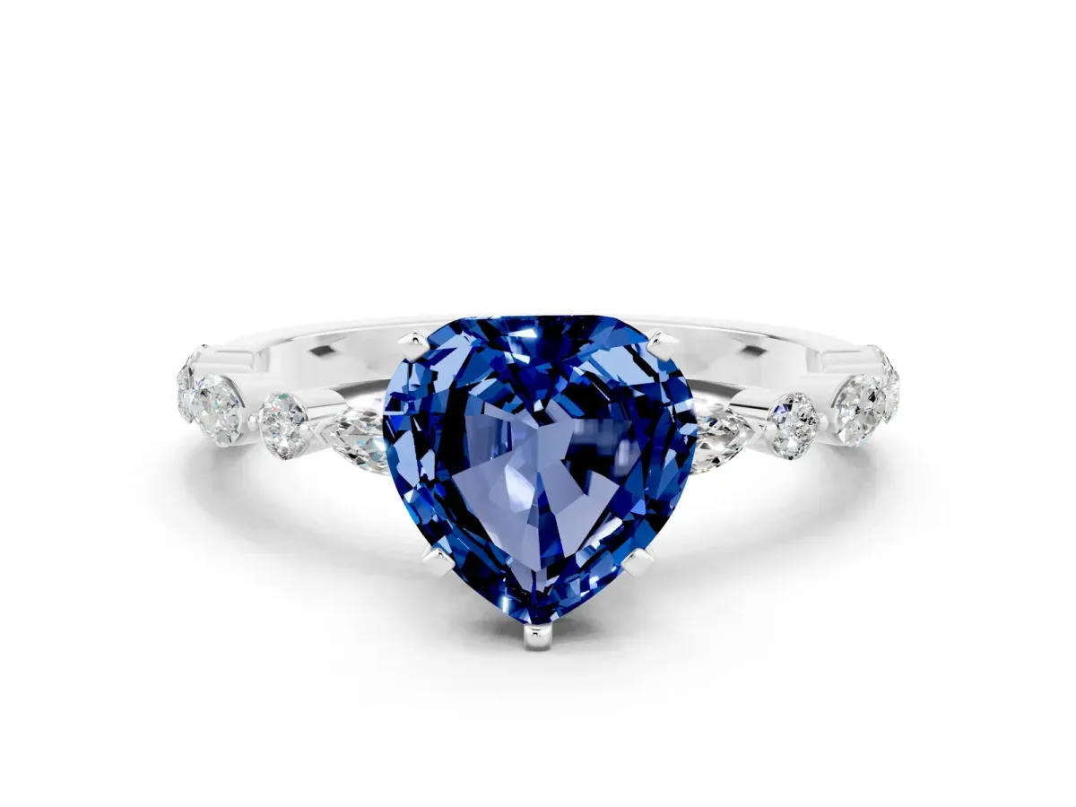 Heart Cut Blue Sapphire Ring with Marquise and Round Side Stones and Four-Prong Setting Silver