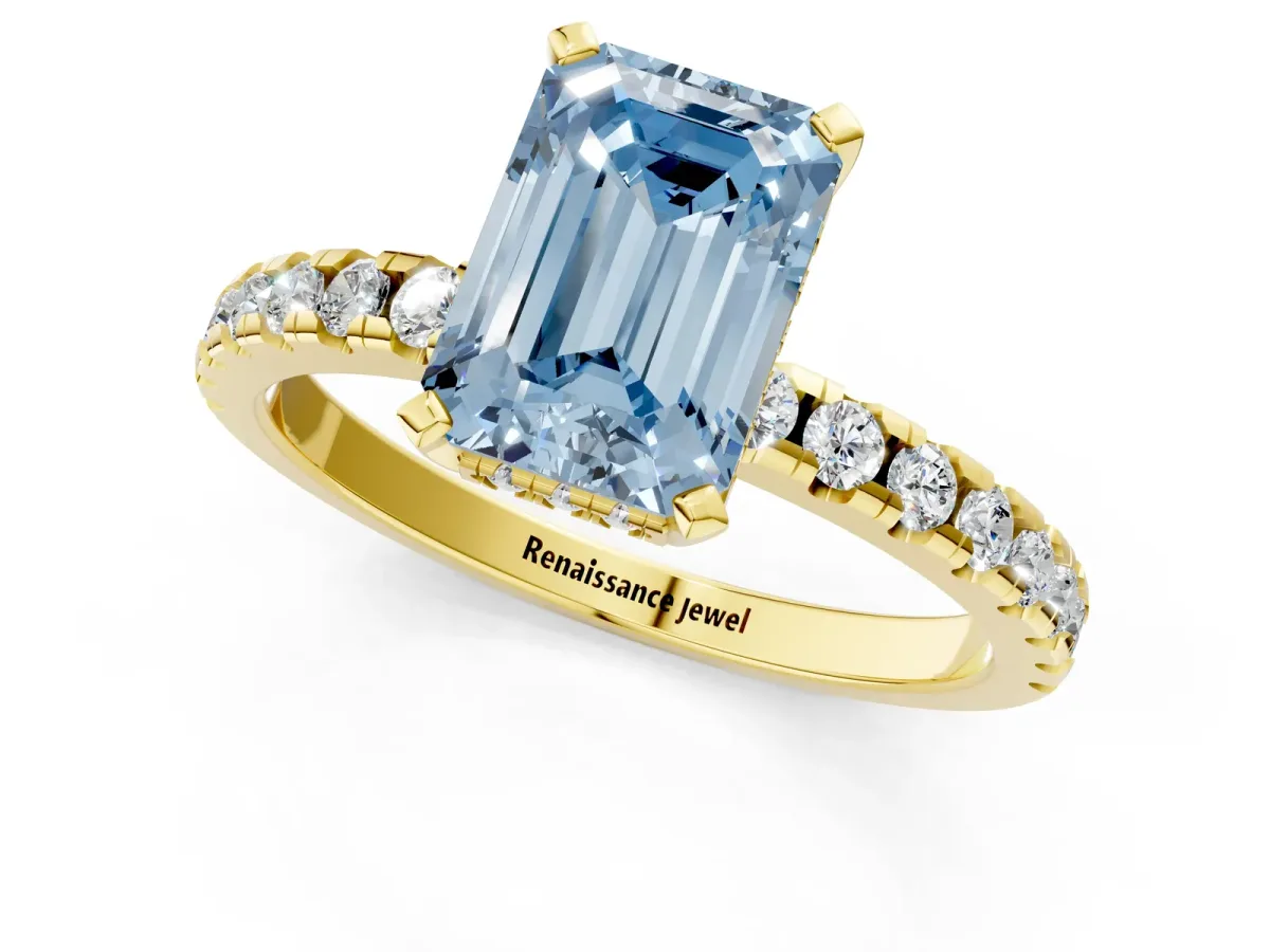 Fancy Blue Emerald Cut Diamond Solitaire Ring with Round Pavé Band and Four-Prong Setting Yellow gold