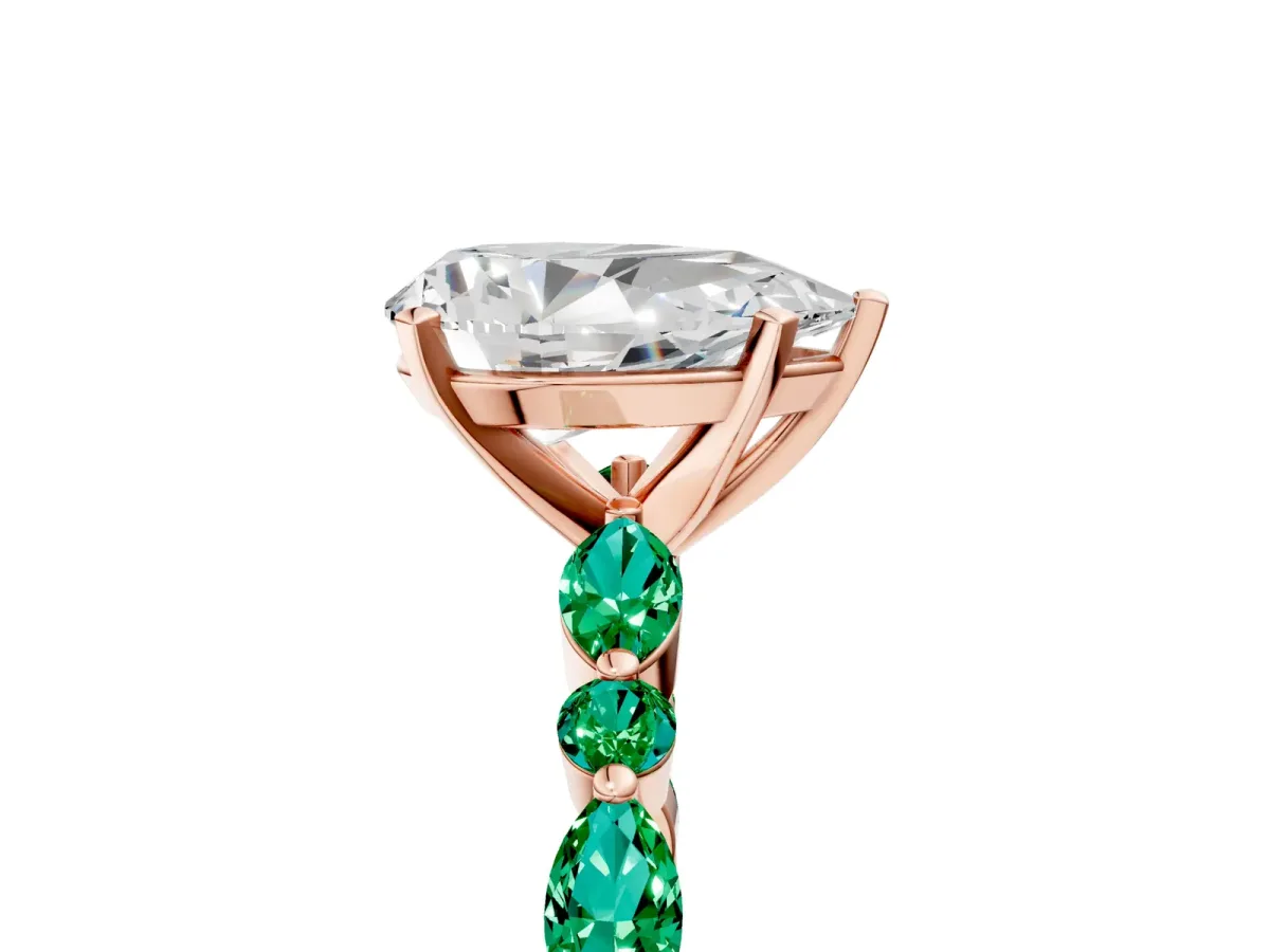 Pear Cut Diamond Ring with Marquise and Round Emerald Side Stones and Four-Prong Setting Rose gold