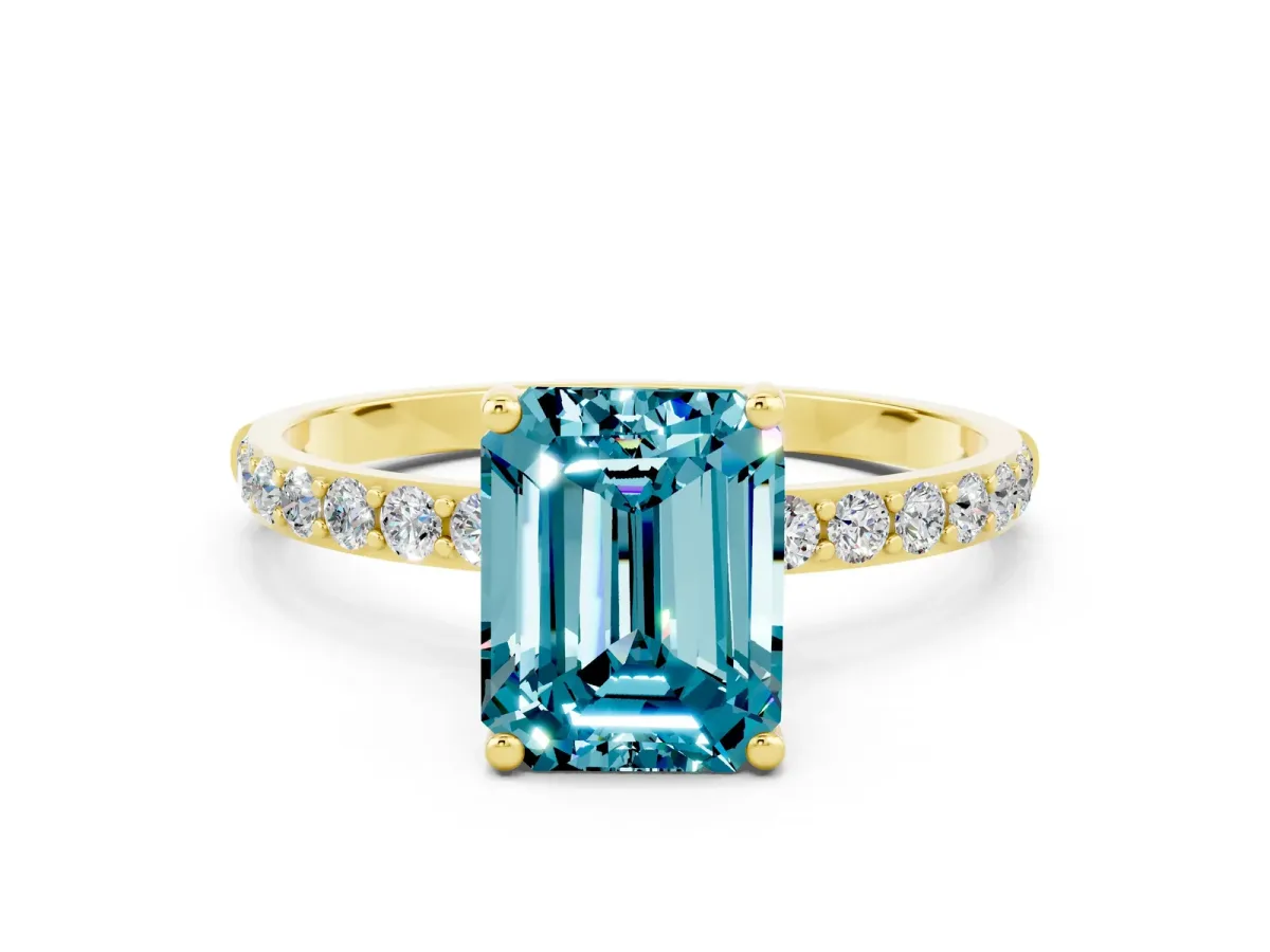 Emerald Cut Blue Topaz Solitaire Ring with Round Pavé Band and Prong Setting Yellow gold
