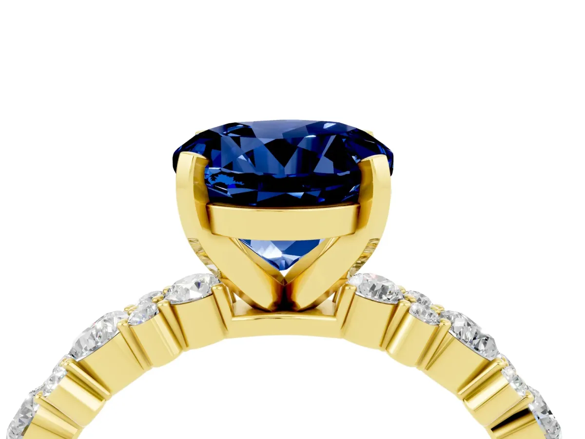 Round Cut Blue Sapphire Side Stone Solitaire Ring with Round and Four-Prong Setting Yellow gold