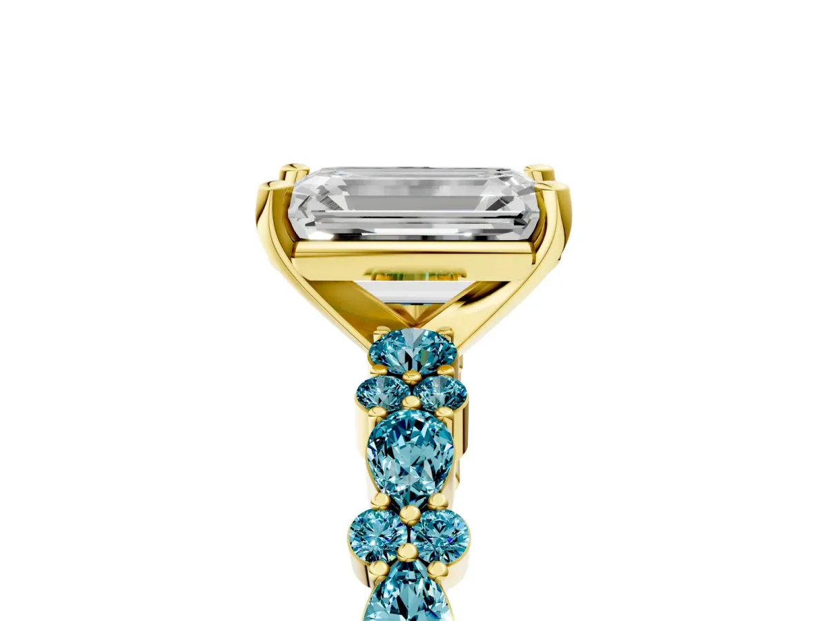Emerald Cut Diamond Side Stone Solitaire Ring with Round Blue Topaz and Four-Prong Setting Yellow gold