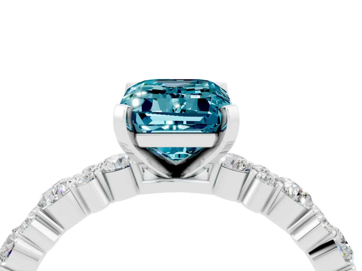 Emerald Cut Blue Topaz Side Stone Solitaire Ring with Round and Four-Prong Setting White gold