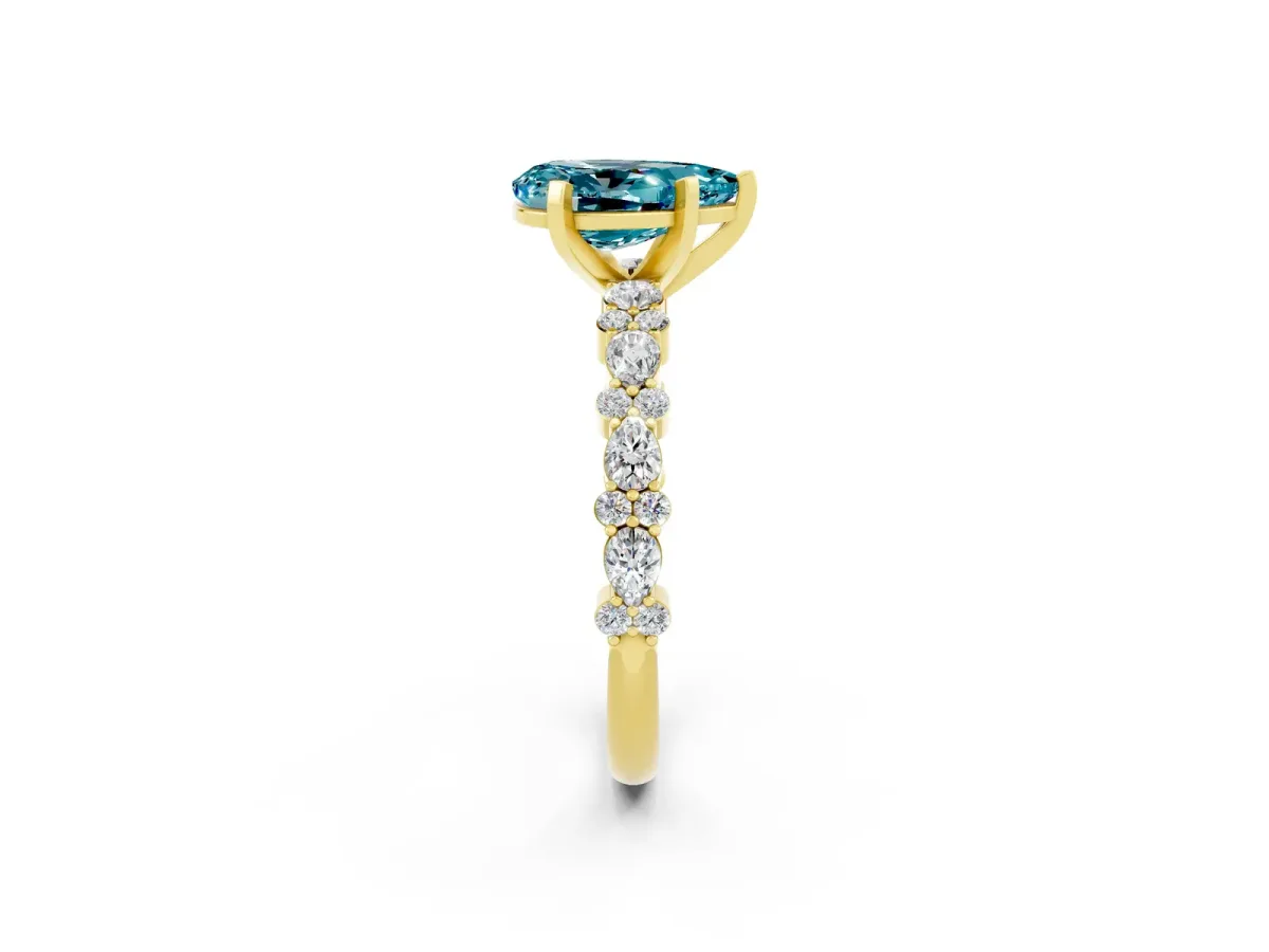 Pear Cut Blue Topaz Side Stone Solitaire Ring with Round and Four-Prong Setting Yellow gold
