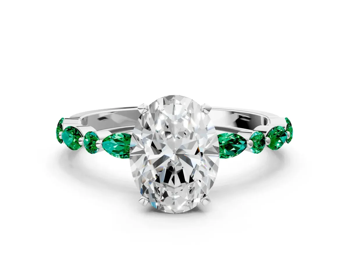 Oval Cut Diamond Ring with Marquise and Round Emerald Side Stones and Four-Prong Setting White gold