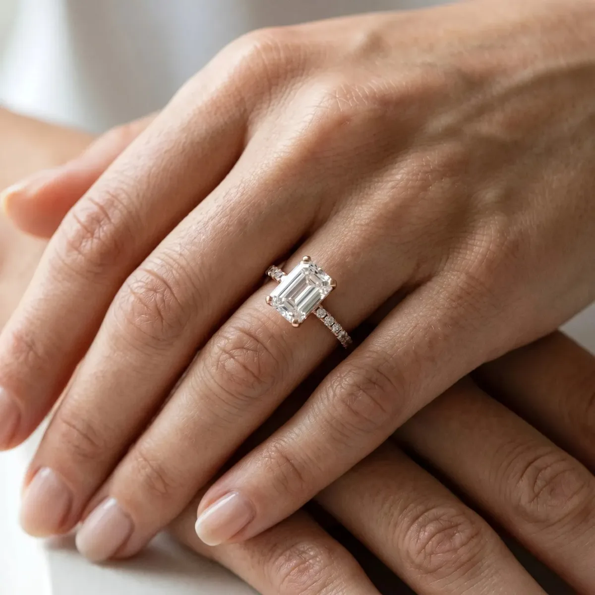 Emerald Cut Diamond Solitaire Ring with Round Pavé Band and Four-Prong Setting Rose gold