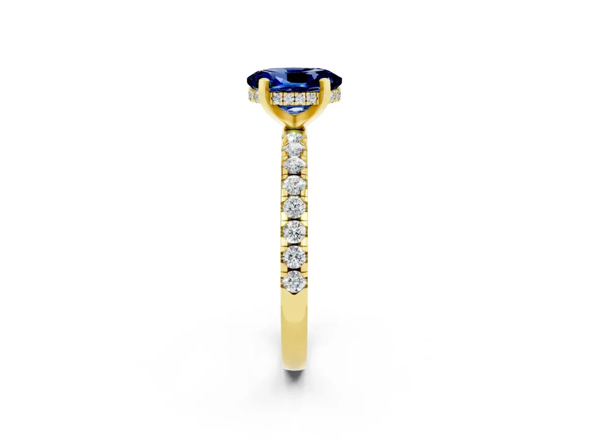 Oval Cut Blue Sapphire Solitaire Ring with Round Pavé Band and Four-Prong Setting Yellow gold