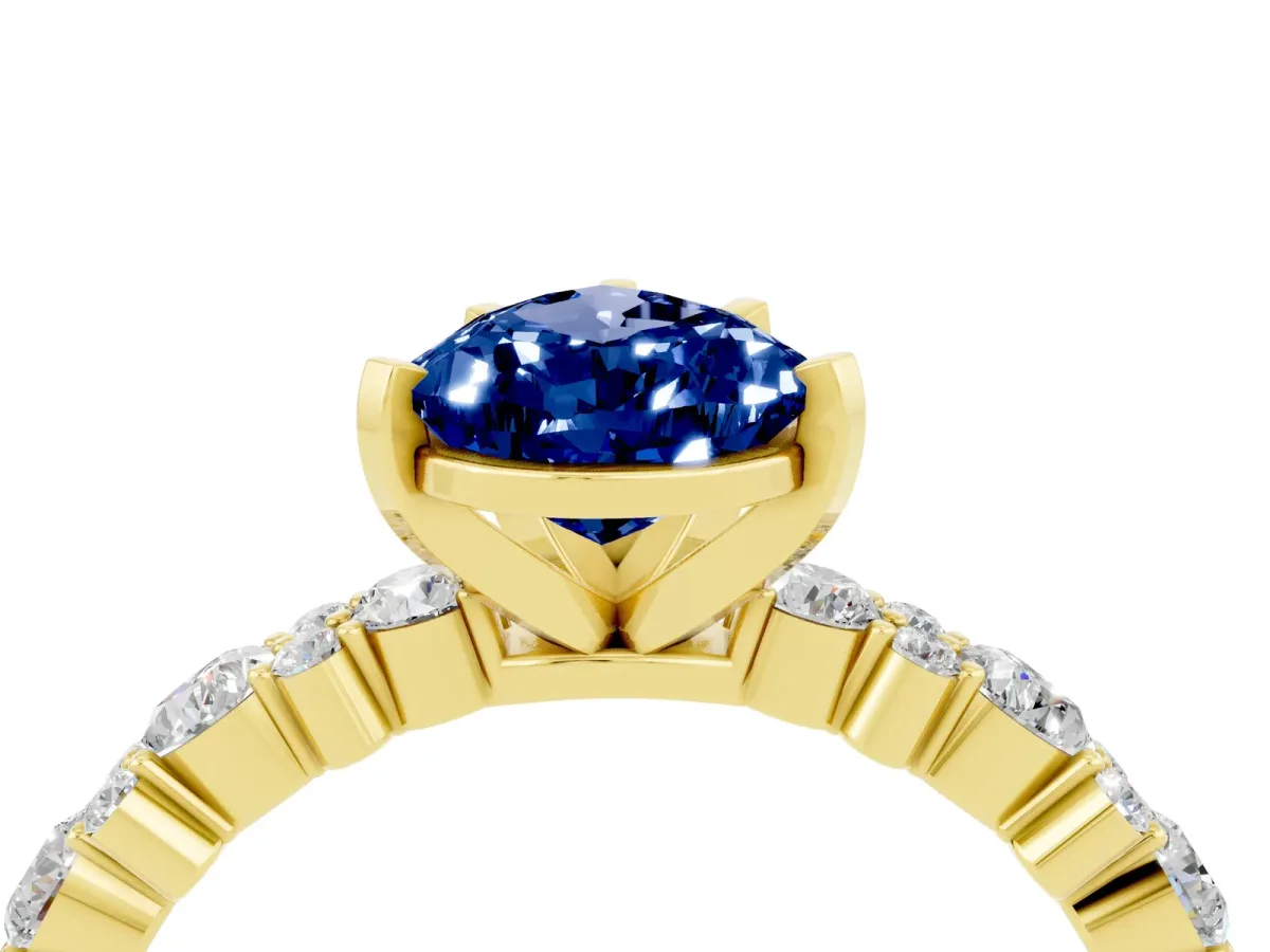 Pear Cut Blue Sapphire Side Stone Solitaire Ring with Round and Four-Prong Setting Yellow gold