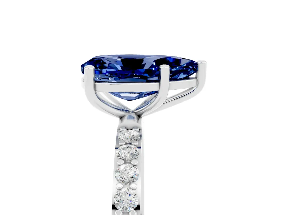 Pear Cut Blue Sapphire Solitaire Ring with Round Pavé Band and Prong Setting Silver