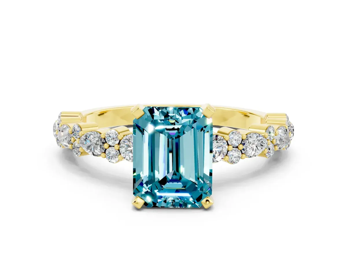 Emerald Cut Blue Topaz Side Stone Solitaire Ring with Round and Four-Prong Setting Yellow gold