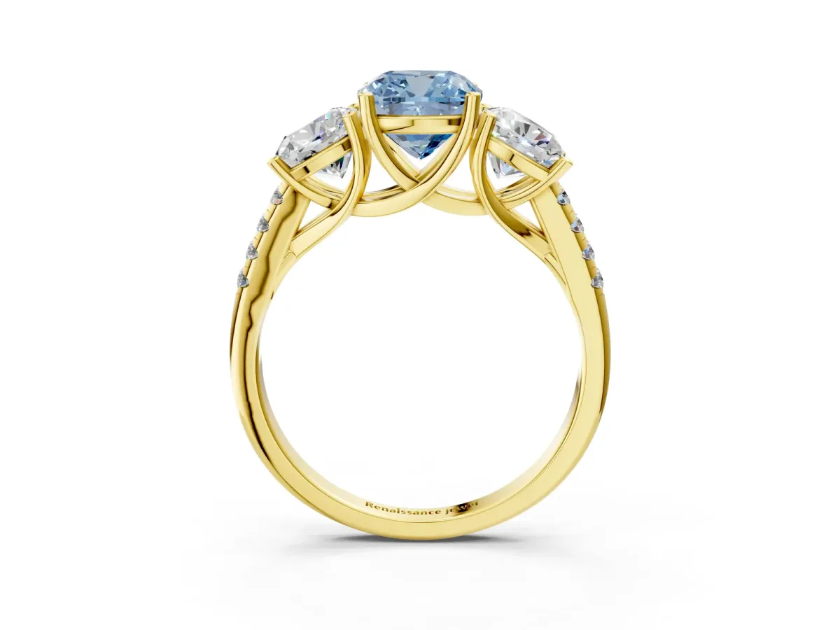 Fancy Blue Three-Stone Cushion Cut Diamond Ring with Round Pavé Band and Prong Setting Yellow gold