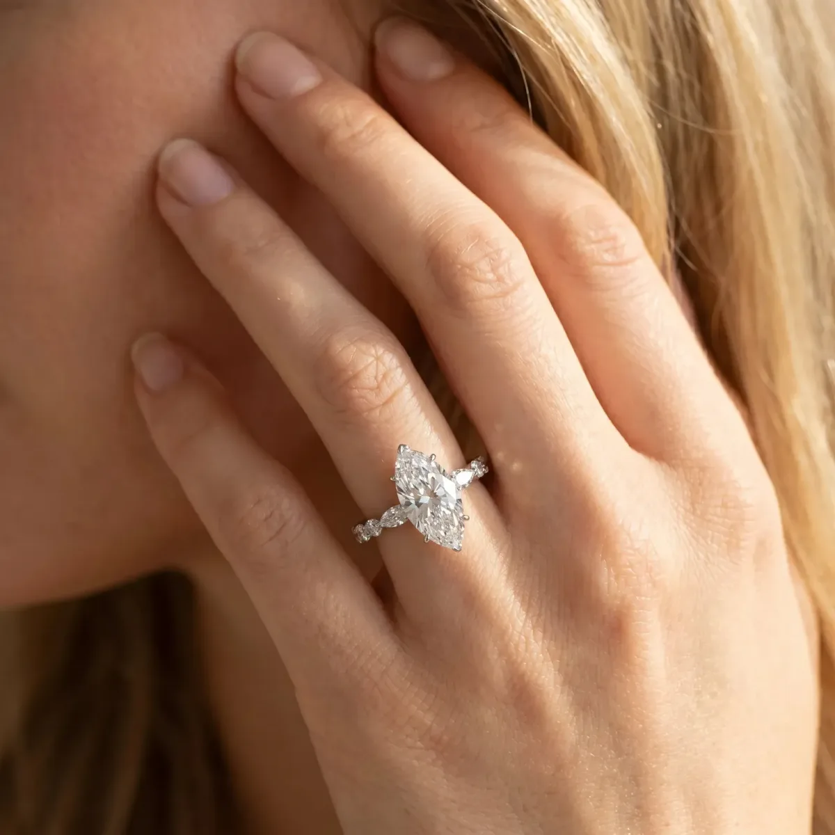 Marquise Cut Diamond Ring with Marquise and Round Side Stones and Four-Prong Setting Silver