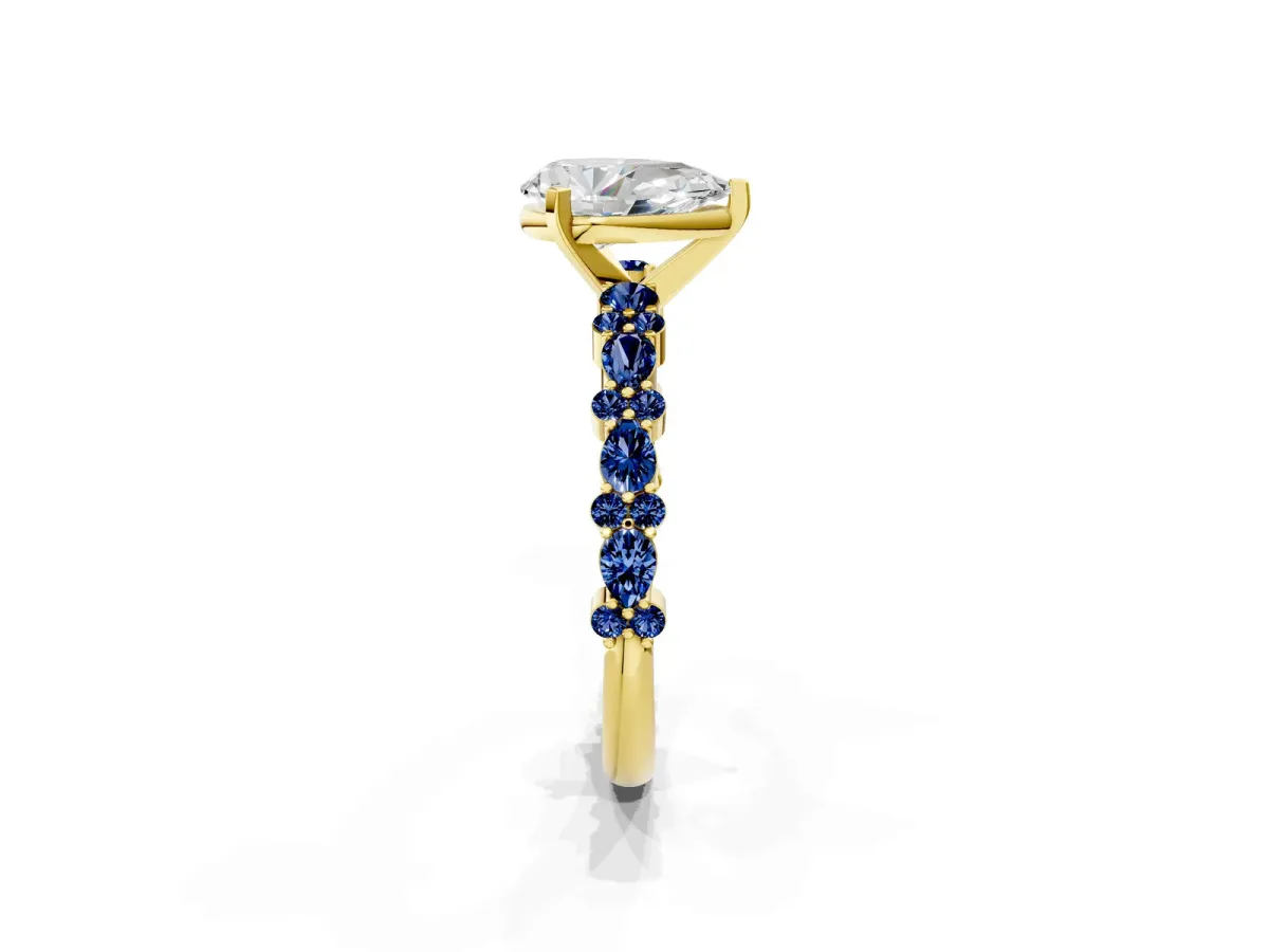 Pear Cut Diamond Side Stone Solitaire Ring with Round Blue Sapphire and Four-Prong Setting Yellow gold