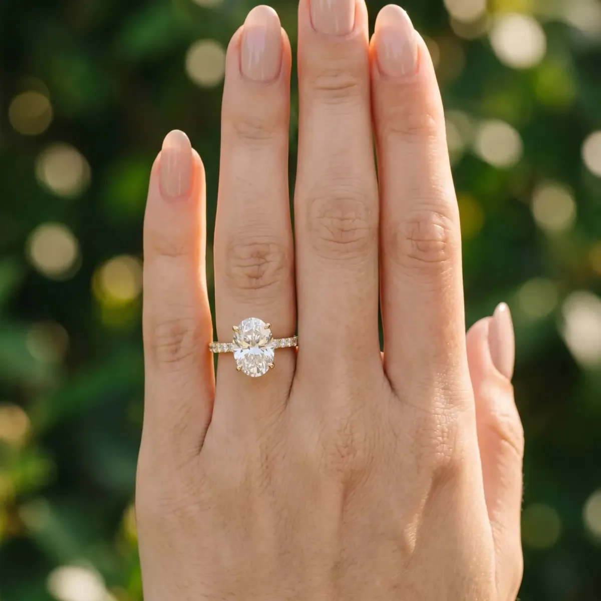 Oval Cut Diamond Solitaire Ring with Round Pavé Band and Prong Setting Yellow gold