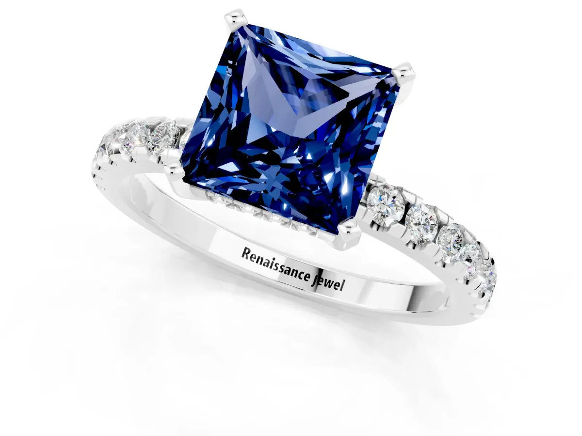 Princess Cut Blue Sapphire Solitaire Ring with Round Pavé Band and Four-Prong Setting Silver