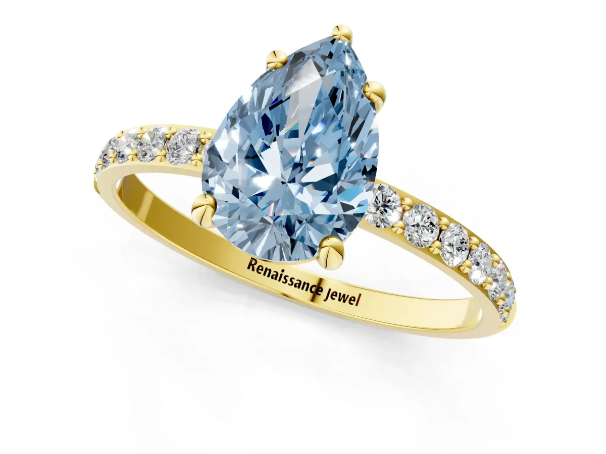 Fancy Blue Pear Cut Diamond Solitaire Ring with Round Pavé Band and Prong Setting Yellow gold