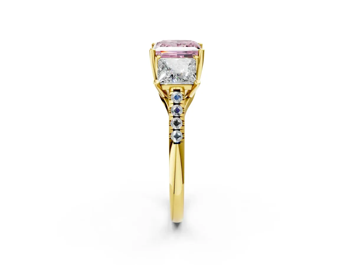 Fancy Pink Three-Stone Princess Cut Diamond Ring with Round Pavé Band and Prong Setting Yellow gold