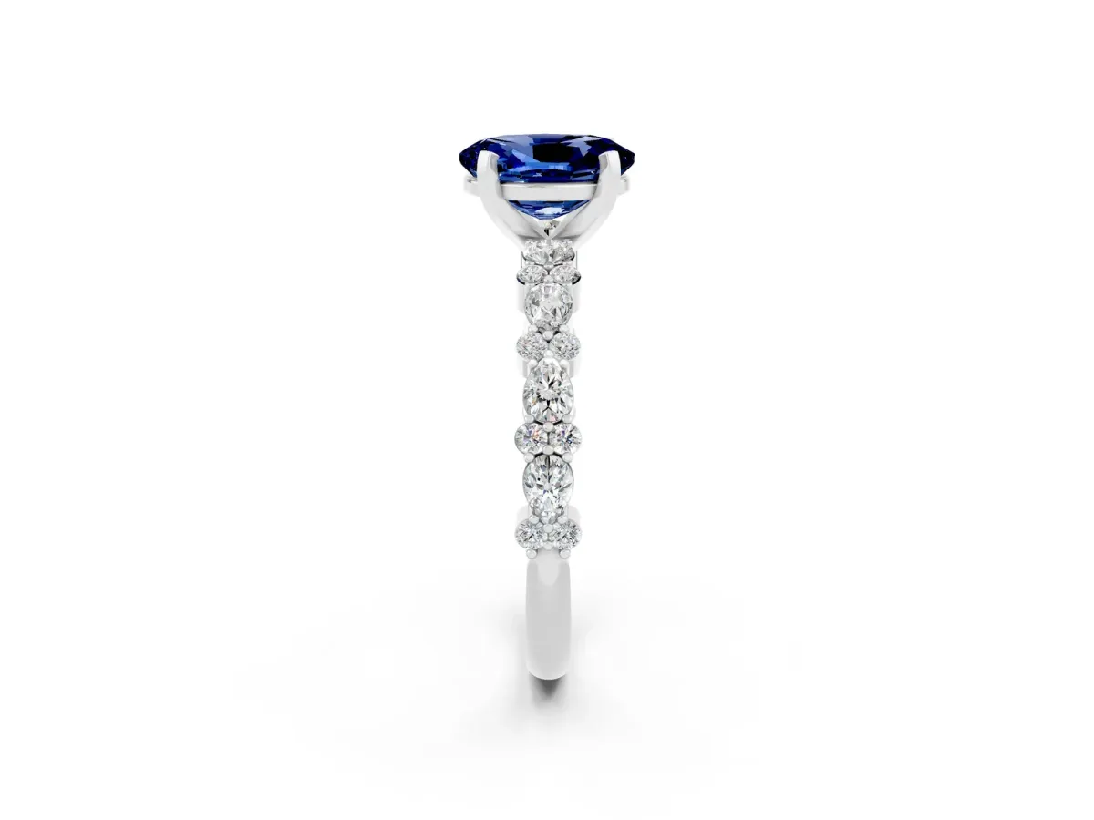 Oval Cut Blue Sapphire Side Stone Solitaire Ring with Round and Four-Prong Setting White gold
