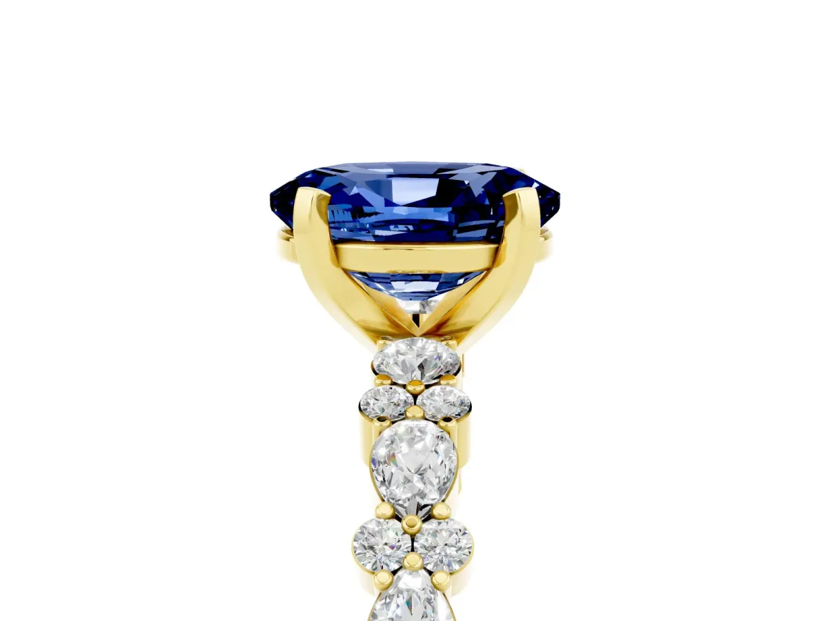Oval Cut Blue Sapphire Side Stone Solitaire Ring with Round and Four-Prong Setting Yellow gold