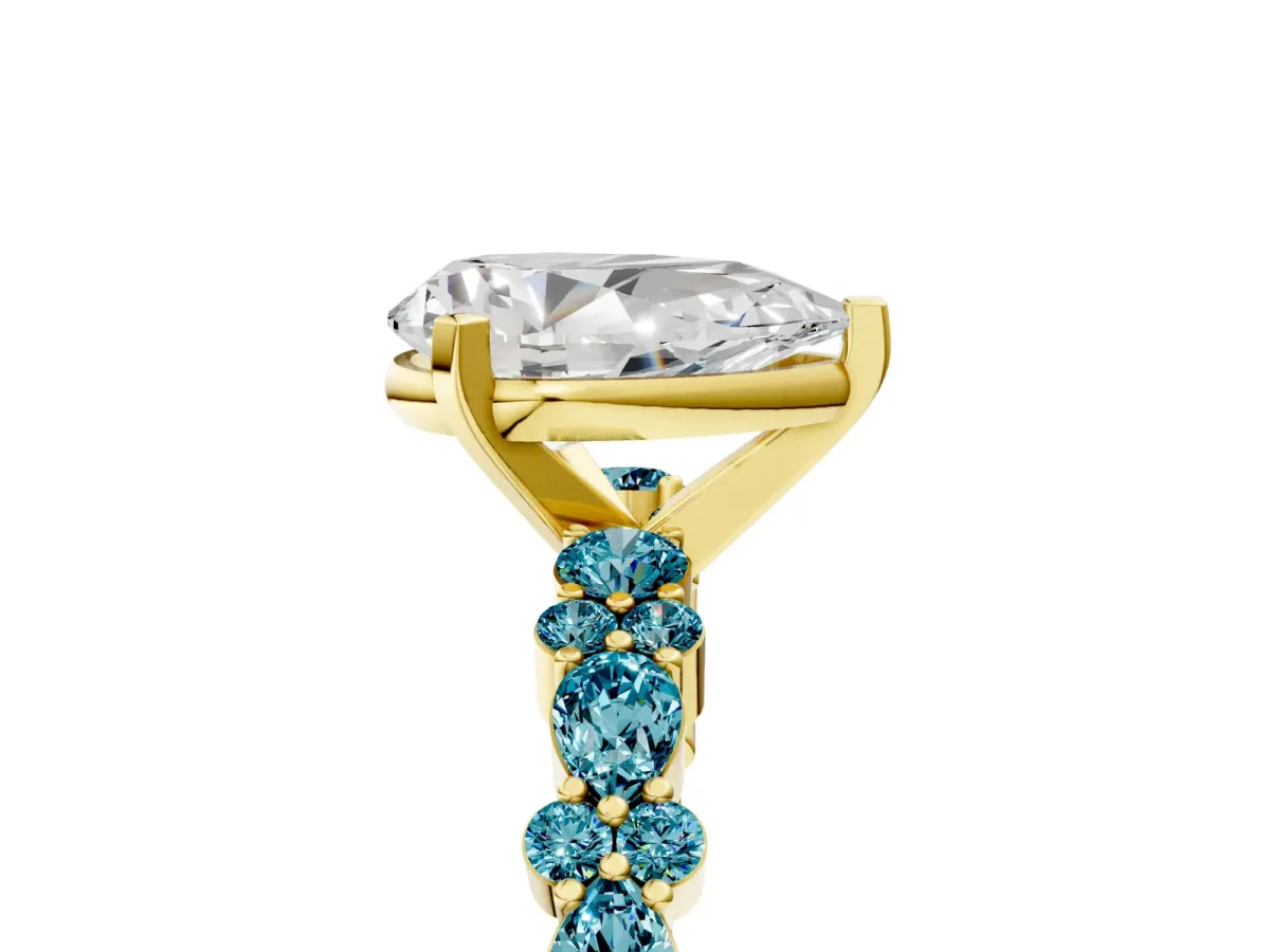 Pear Cut Diamond Side Stone Solitaire Ring with Round Blue Topaz and Four-Prong Setting Yellow gold