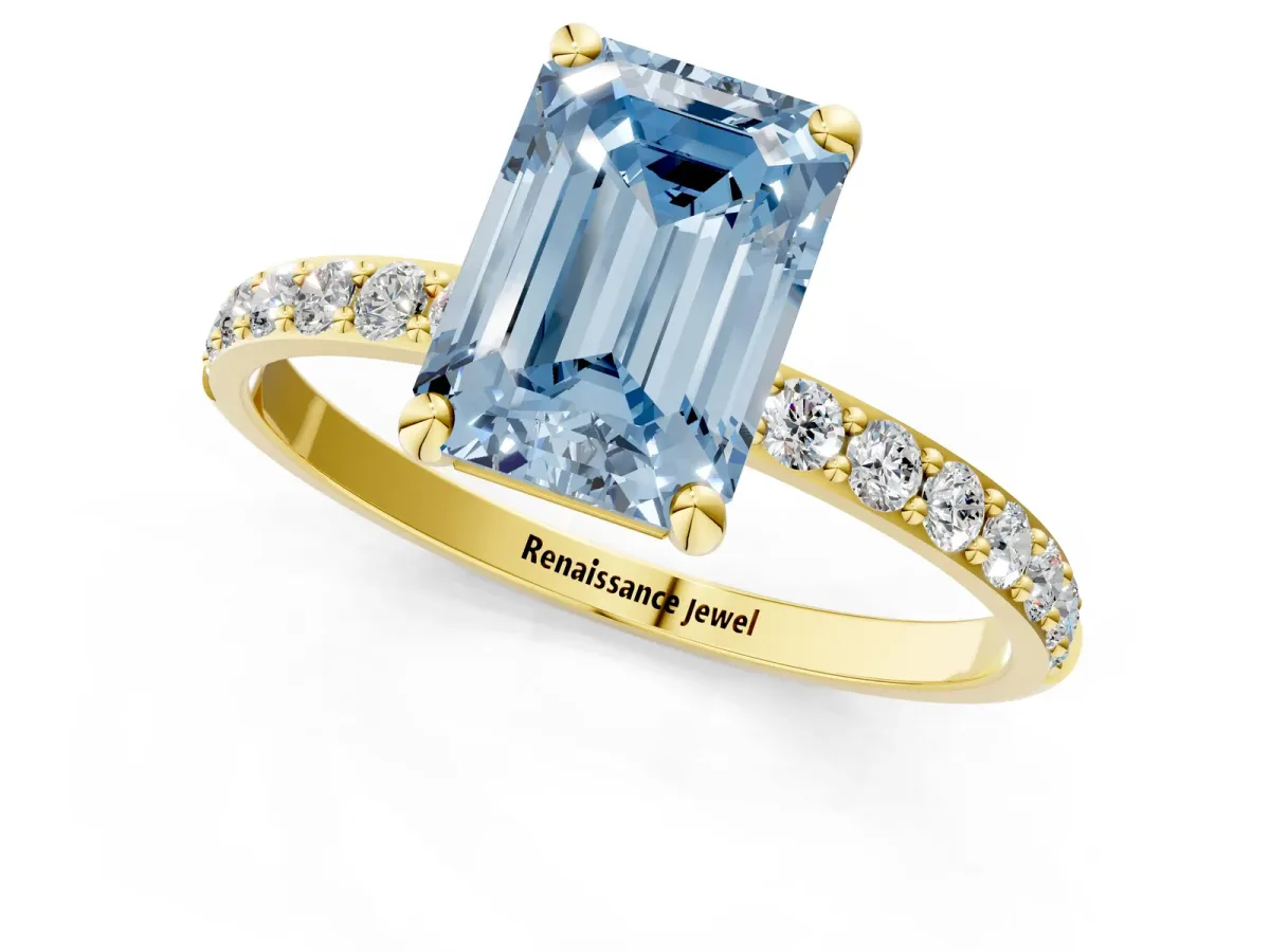 Fancy Blue Emerald Cut Diamond Solitaire Ring with Round Pavé Band and Prong Setting Yellow gold