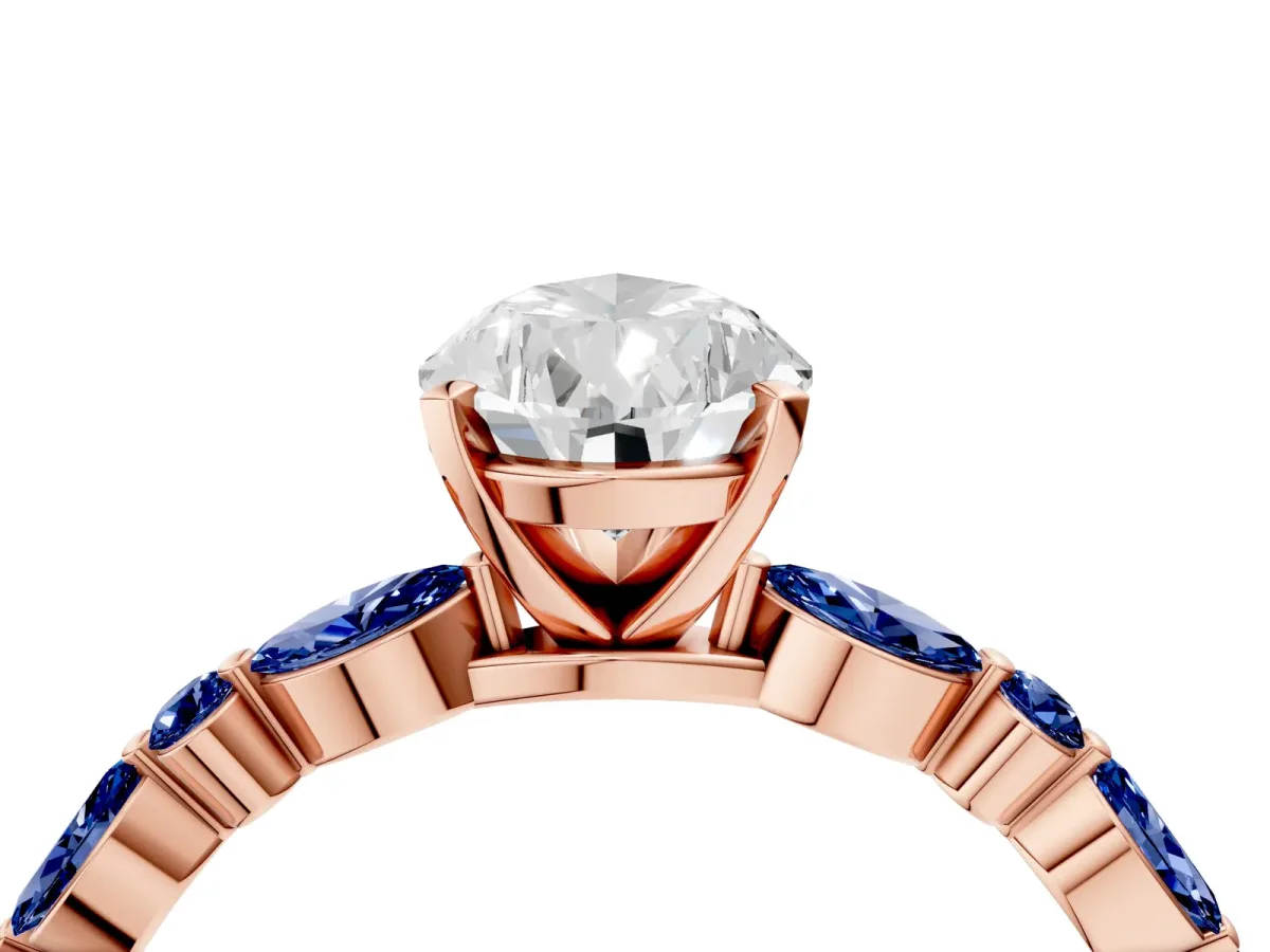 Pear Cut Diamond Ring with Marquise and Round Blue Sapphire Side Stones and Four-Prong Setting Rose gold