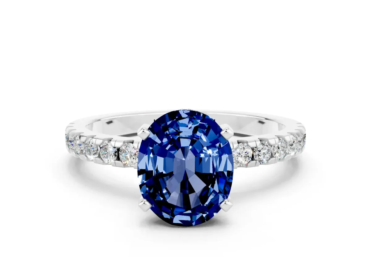 Oval Cut Blue Sapphire Solitaire Ring with Round Pavé Band and Four-Prong Setting Silver
