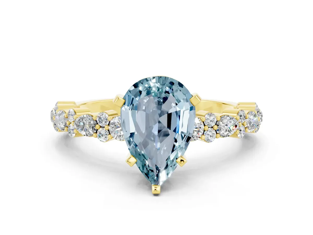 Pear Cut Aquamarine Side Stone Solitaire Ring with Round and Four-Prong Setting Yellow gold