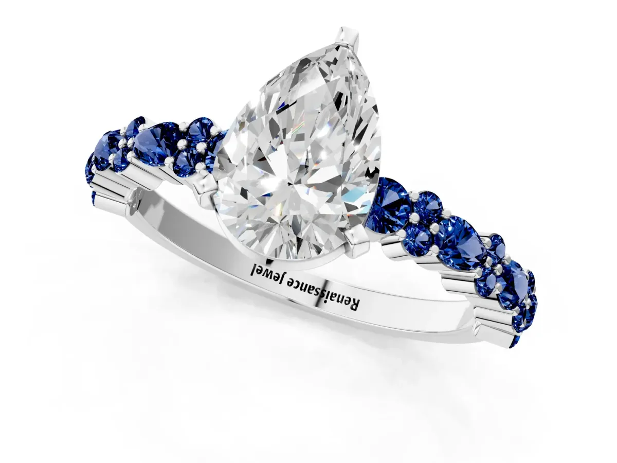 Pear Cut Diamond Side Stone Solitaire Ring with Round Blue Sapphire and Four-Prong Setting Platinum
