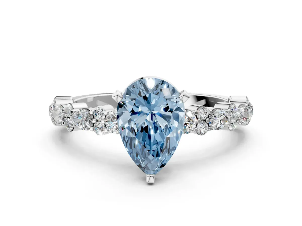 Fancy Blue Pear Cut Diamond Side Stone Solitaire Ring with Round and Four-Prong Setting Platinum