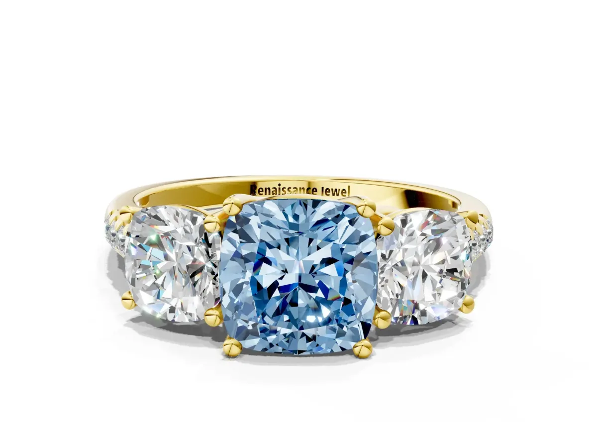 Fancy Blue Three-Stone Cushion Cut Diamond Ring with Round Pavé Band and Prong Setting Yellow gold