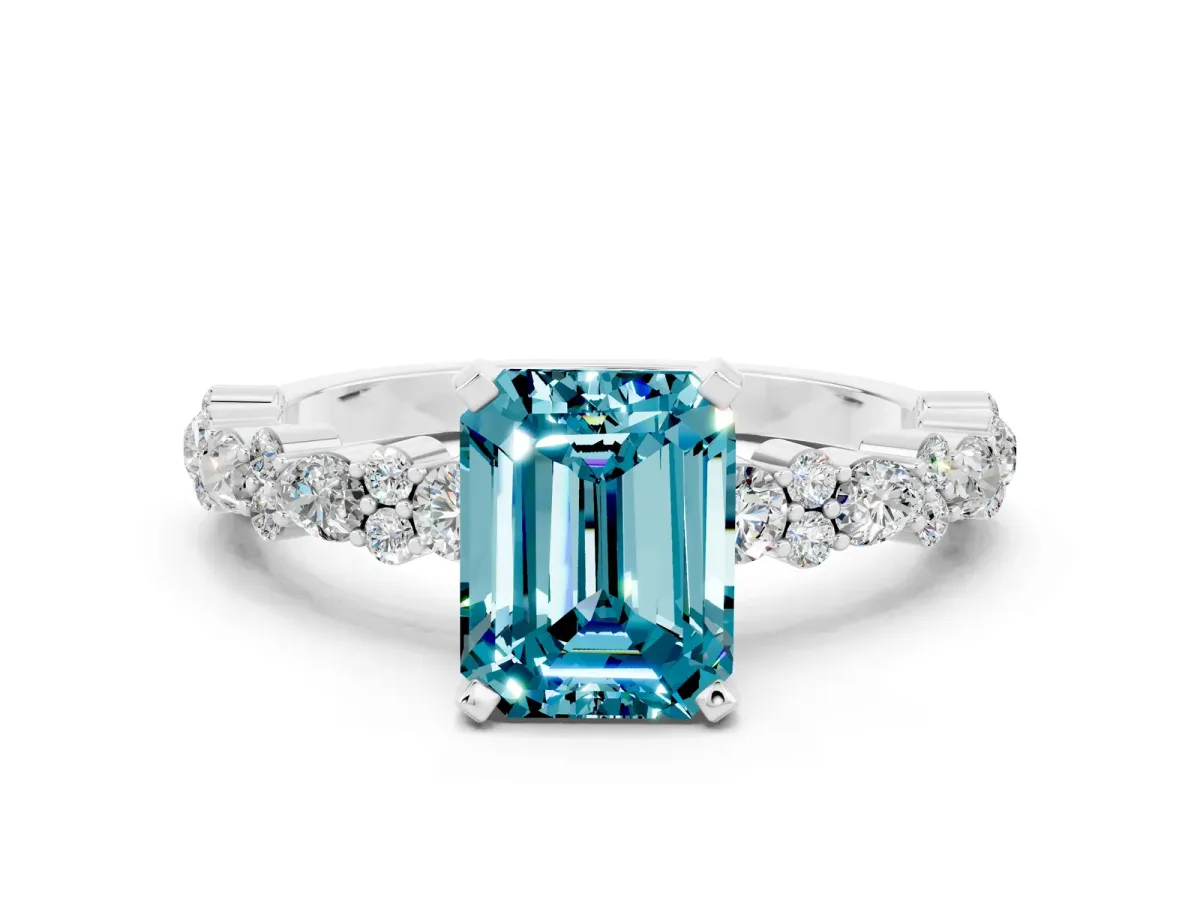 Emerald Cut Blue Topaz Side Stone Solitaire Ring with Round and Four-Prong Setting White gold