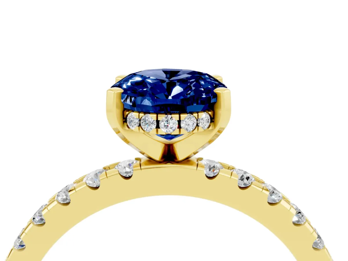 Oval Cut Blue Sapphire Solitaire Ring with Round Pavé Band and Four-Prong Setting Yellow gold