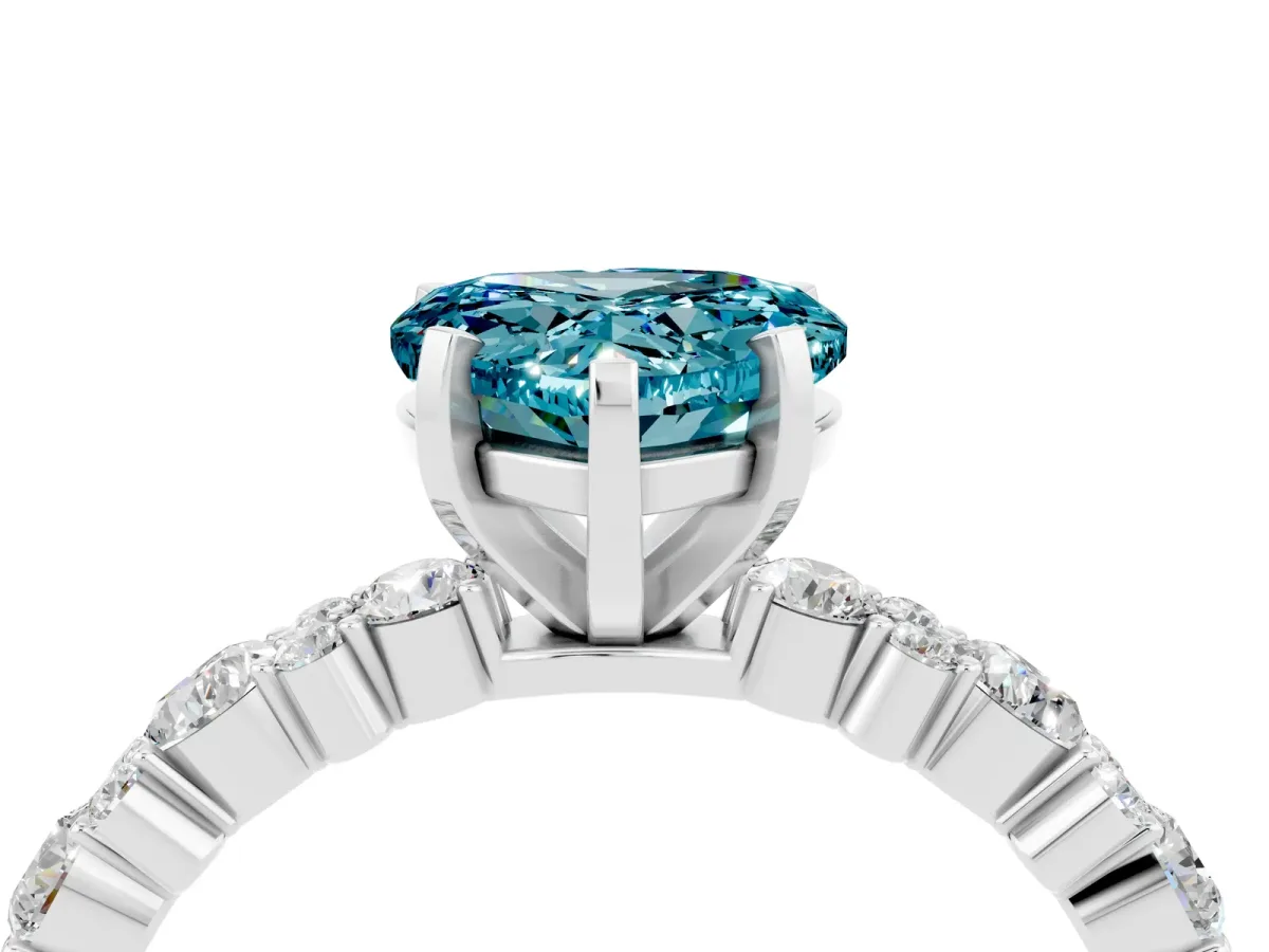 Heart Cut Blue Topaz Side Stone Solitaire Ring with Round and Four-Prong Setting Platinum