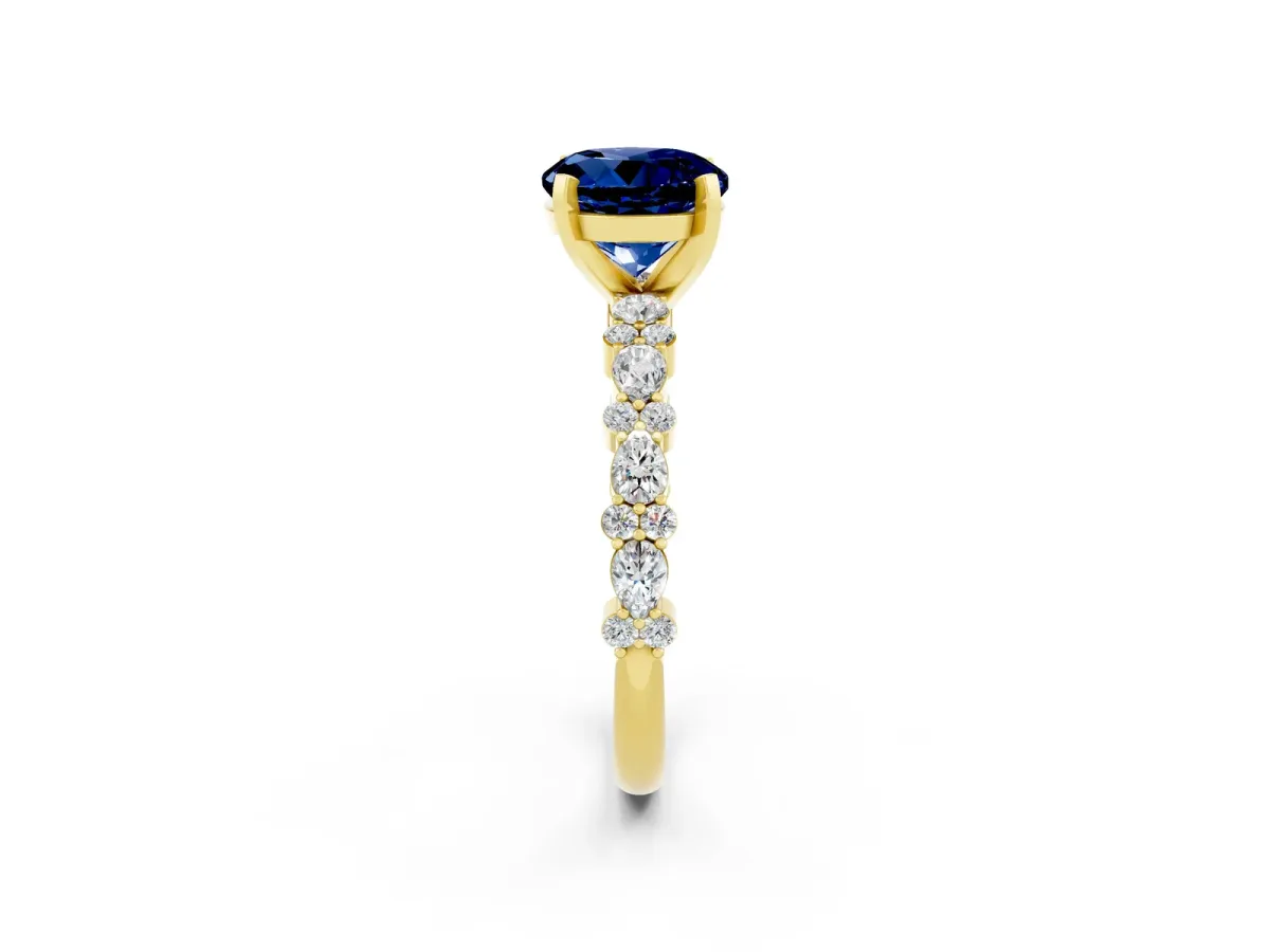 Round Cut Blue Sapphire Side Stone Solitaire Ring with Round and Four-Prong Setting Yellow gold