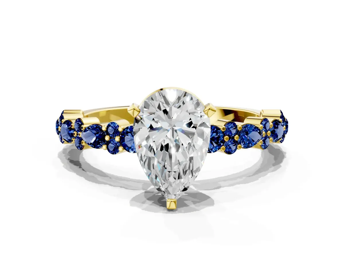 Pear Cut Diamond Side Stone Solitaire Ring with Round Blue Sapphire and Four-Prong Setting Yellow gold