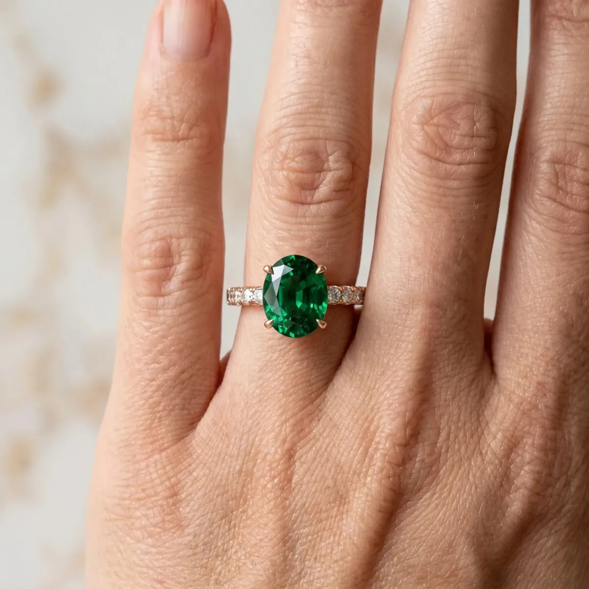 Oval Cut Emerald Solitaire Ring with Round Pavé Band and Four-Prong Setting Rose gold