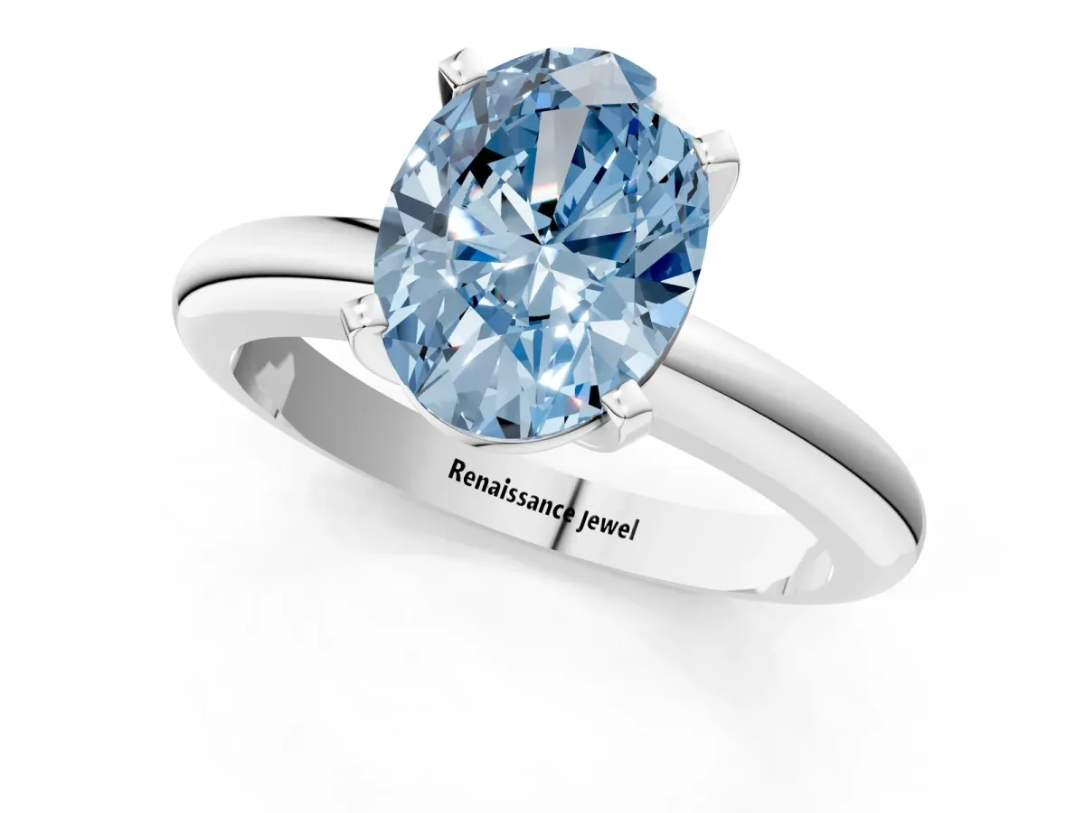 Fancy Blue Oval Cut Diamond Solitaire Engagement Ring with Round Band and Four-Prong Setting White gold