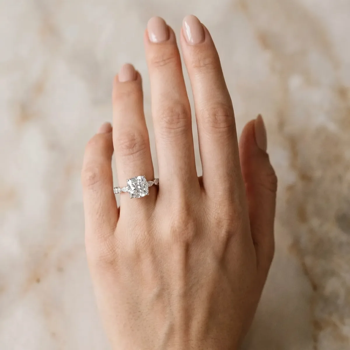 Cushion Cut Diamond Ring with Marquise and Round Side Stones and Four-Prong Setting Silver