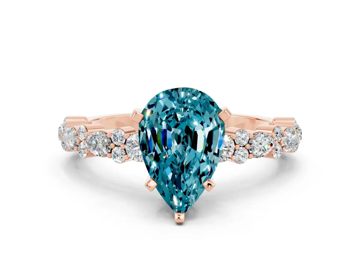 Pear Cut Blue Topaz Side Stone Solitaire Ring with Round and Four-Prong Setting Rose gold