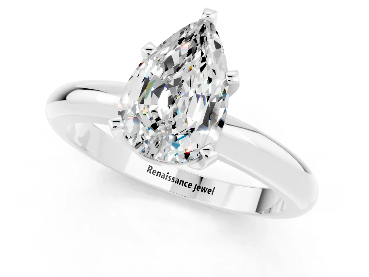 Pear Cut Moissanite Solitaire Engagement Ring with Round Band and Four-Prong Setting Silver