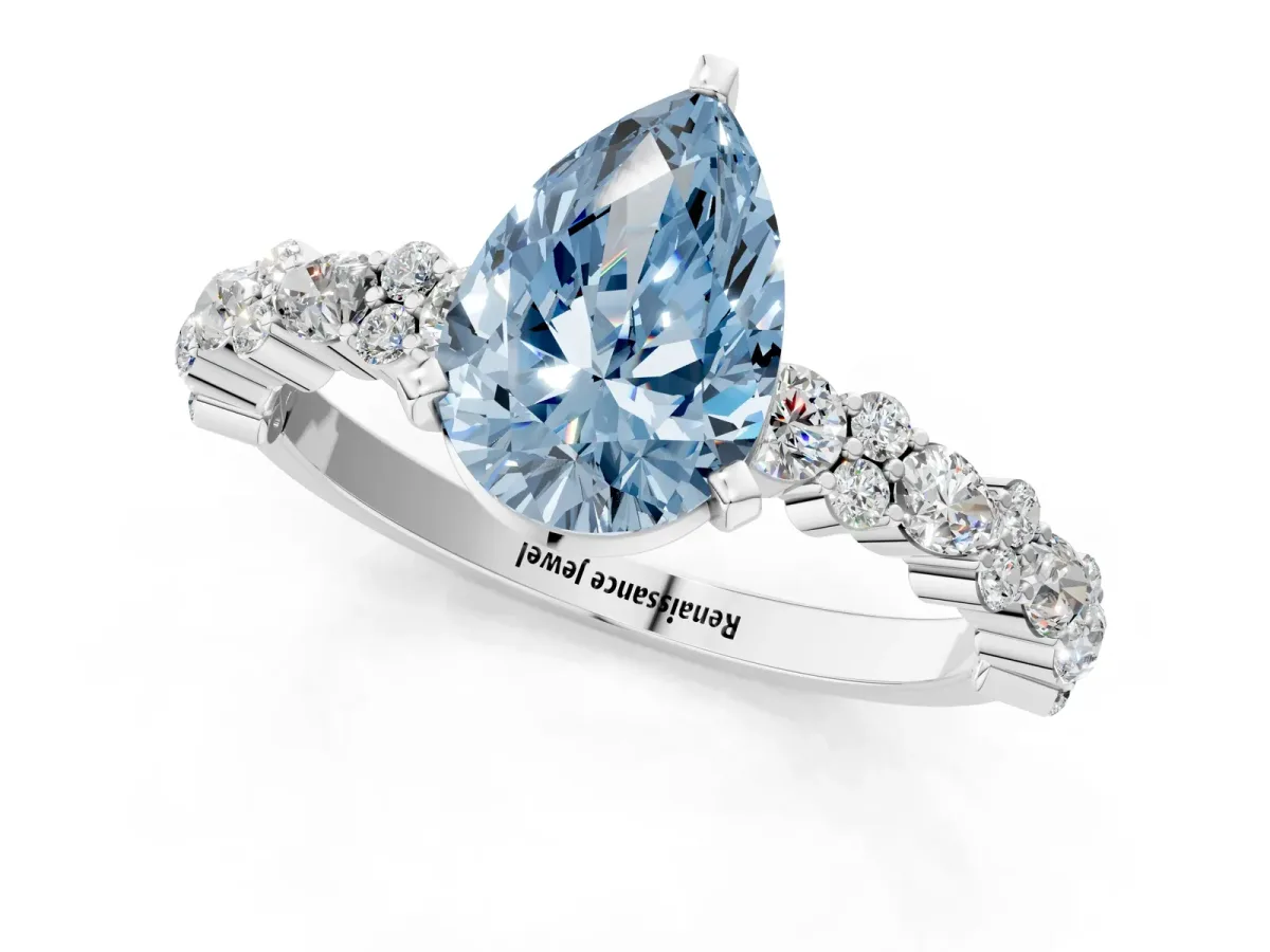 Fancy Blue Pear Cut Diamond Side Stone Solitaire Ring with Round and Four-Prong Setting Platinum