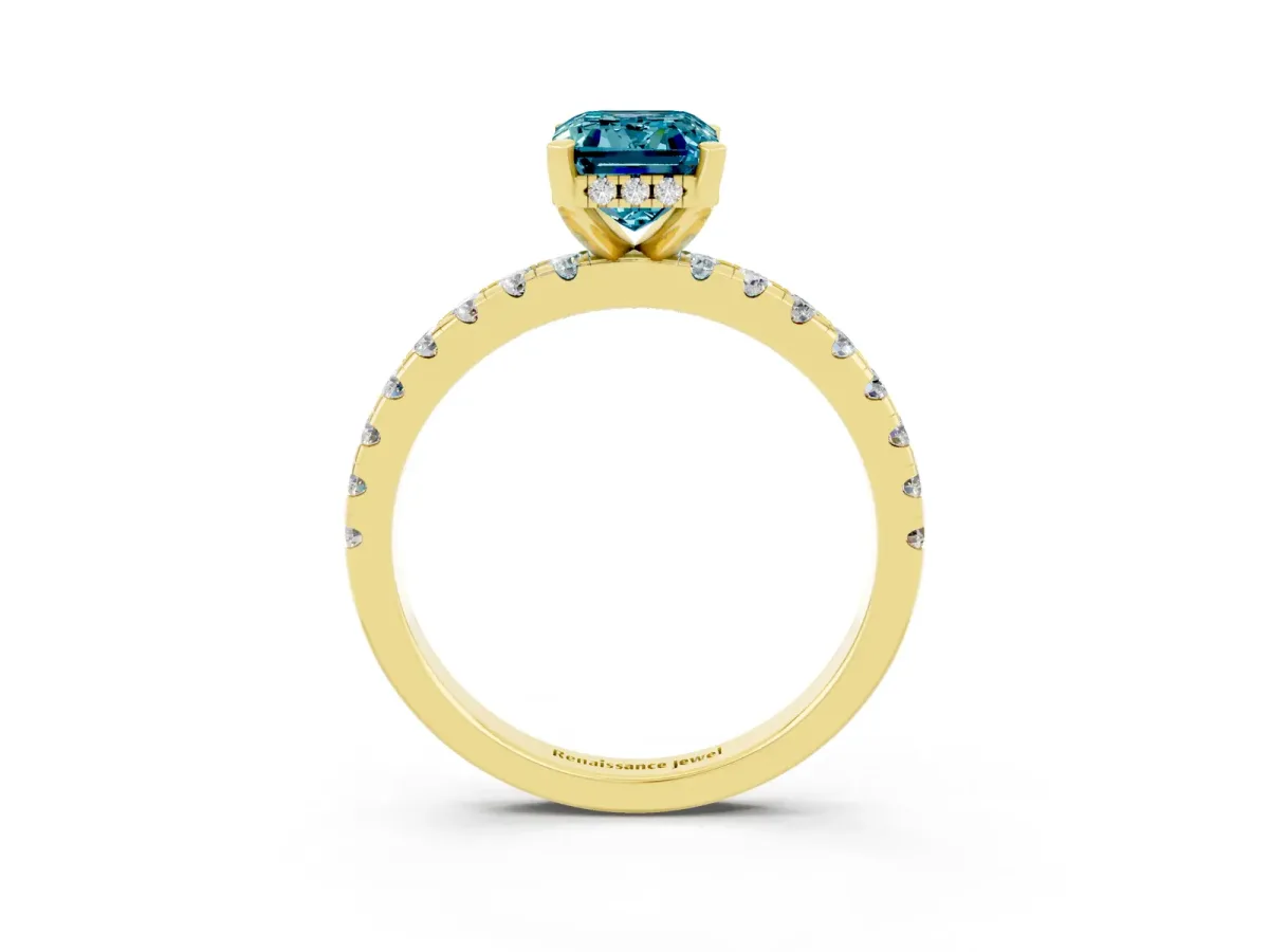 Emerald Cut Blue Topaz Solitaire Ring with Round Pavé Band and Four-Prong Setting Yellow gold