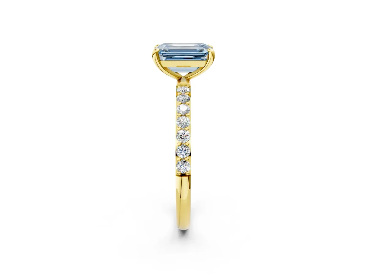 Fancy Blue Emerald Cut Diamond Solitaire Ring with Round Pavé Band and Prong Setting Yellow gold