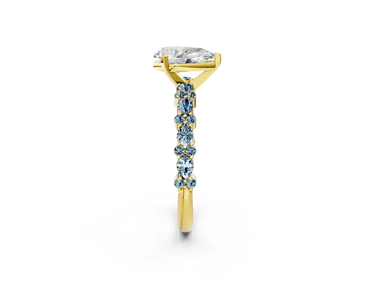 Pear Cut Diamond Side Stone Solitaire Ring with Round Aquamarine and Four-Prong Setting Yellow gold