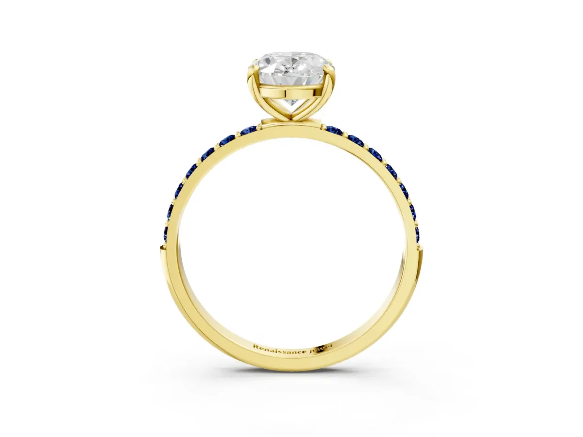 Oval Cut Diamond Solitaire Ring with Round Blue Sapphire Pavé Band and Prong Setting Yellow gold